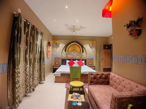 a hotel room with a bed and a couch at The Sea Horse in Mandarmoni