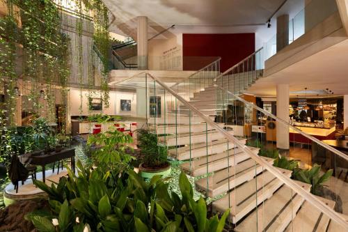 a staircase in a building with plants at Four Points by Sheraton Catania Hotel in Catania