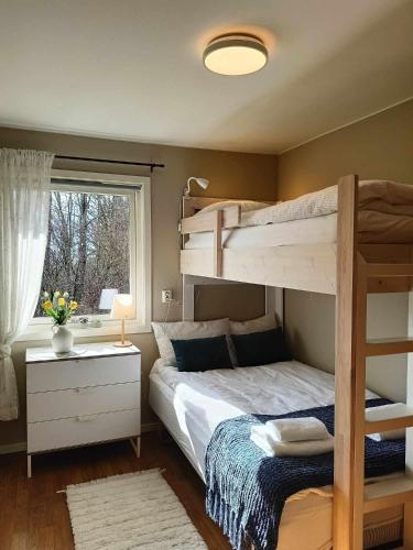 a bedroom with two bunk beds and a window at Holiday home in Steinkjer in Steinkjer
