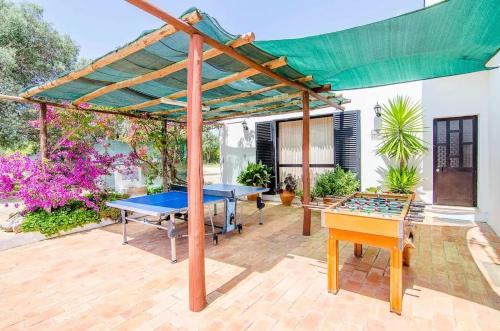 a patio with a ping pong table and a canopy at Elegant Villa in Loulé with Private Pool in Loulé
