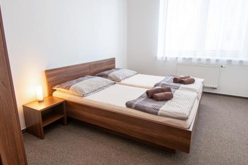 a bedroom with a bed with two towels on it at Penzion Na Dlouhé in Uherské Hradiště