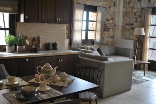 a living room with a couch and a table at Halkidiki Luxurious Stonehouses in Psakoudia