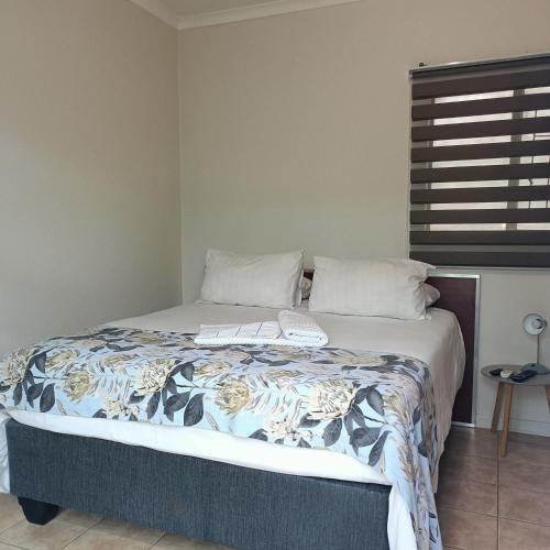 a bedroom with a bed with a keyboard on it at 21 On Coetzee Guest House in Bloemfontein
