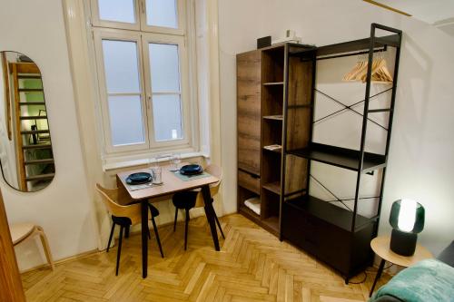 a small room with a table and a shelf at Studio Apartment - 5 min from City Center with AC in Budapest