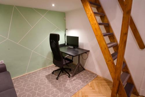 a room with a desk with a computer on it at Studio Apartment - 5 min from City Center with AC in Budapest