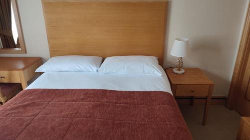 a bedroom with a large bed with a wooden headboard at Vista sul Corso rooms in Rome