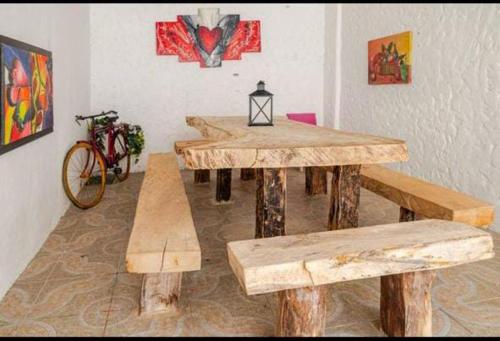 a group of wooden tables and benches in a room at casa real in Cartagena de Indias