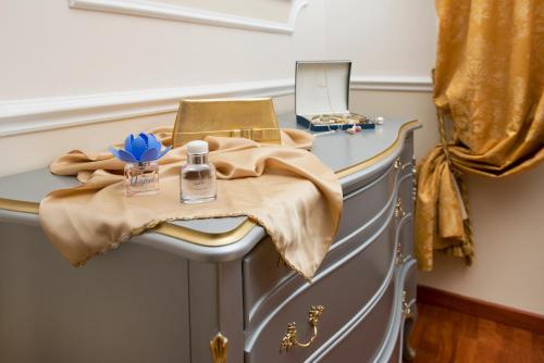 a dressing table with a bottle of perfume on it at Hotel Villa Medici in Rocca San Giovanni