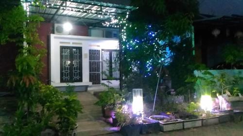 a house with a lit up front yard at night at Beautiful Family Villa Semarang in Alastuwo