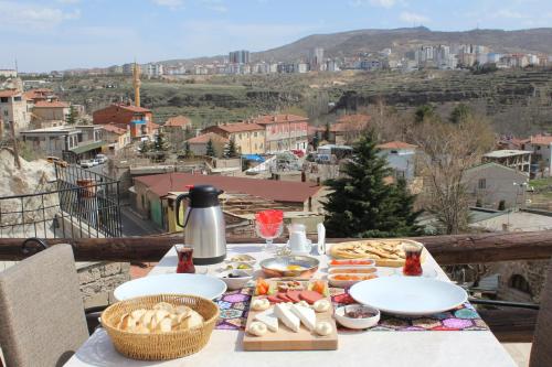 a table with food and a view of a city at LA DiAS CAVE CAPPADOCİA in Nar
