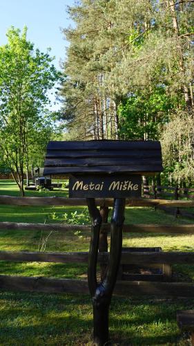 a park bench with the words metal music on it at Metai mikeA year in the forest in Paliepis