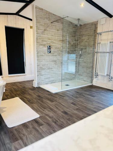 a bathroom with a shower with a glass door at Sneaton Castle in Whitby