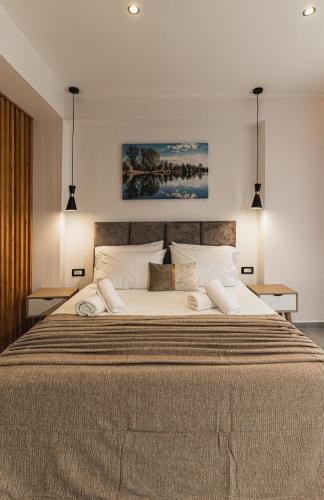 a bedroom with a large bed with two pillows at Lumior Villas Lux essence by 'elite' in Zakynthos Town