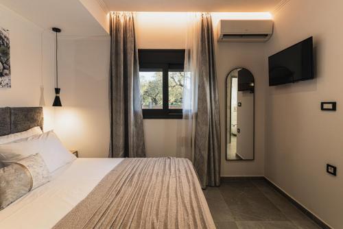 a bedroom with a bed and a window at Lumior Villas Lux essence by 'elite' in Zakynthos Town