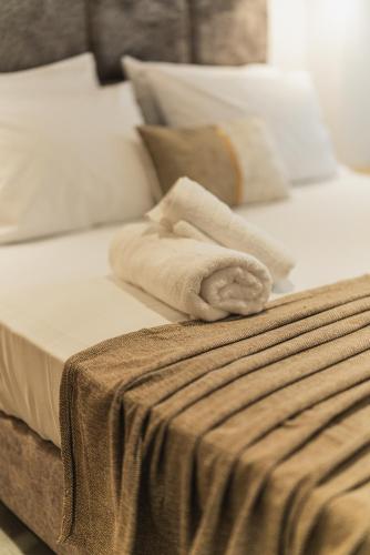 a bed with a towel on top of it at Lumior Villas Lux essence by 'elite' in Zakynthos Town