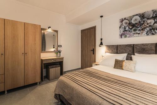 a bedroom with a bed and a desk and a mirror at Lumior Villas Lux essence by 'elite' in Zakynthos Town
