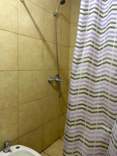 a shower curtain in a bathroom with a sink at Depto 3 in Río Cuarto