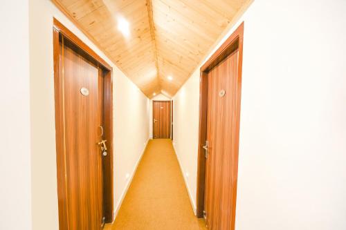 an empty corridor with two doors in a building at The Castle in Kūfrī