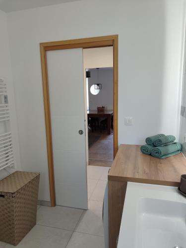 a kitchen with a door leading to a dining room at Le Relais in Fumay