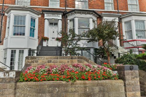 a house with a bunch of flowers in front of it at Glenholme Guest House - Room Only in Scarborough