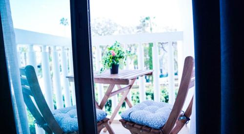 a table and chairs on a porch with a potted plant at Az Hotel Rabat Centre in Rabat
