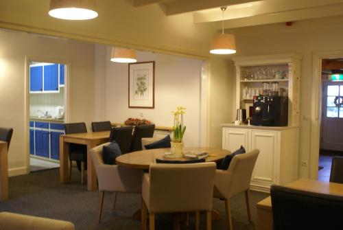 a dining room with a table and chairs at Pension De Hoestinkhof in Markelo
