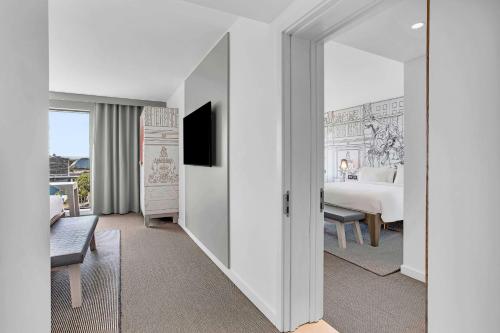 a white room with a bed and a television at Radisson RED Hotel, Glasgow in Glasgow