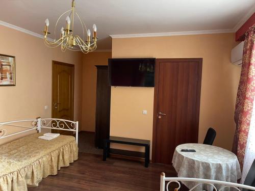 a hotel room with two beds and a chandelier at Hotel Domashnii in Zhytomyr