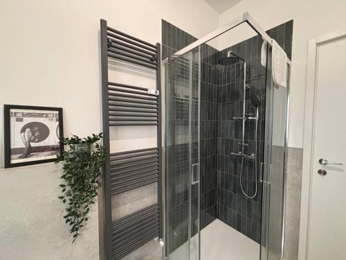 a bathroom with a shower with a glass door at Casa Angelina in Barlassina
