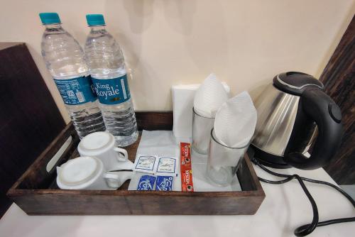 a tray with bottles of water and other items on a counter at Puri Inn in Varanasi