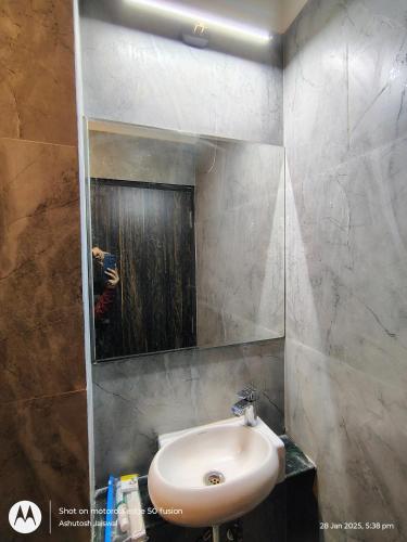 a bathroom with a sink and a mirror at Puri Inn in Varanasi