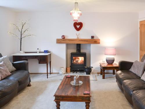 a living room with a couch and a fireplace at The Dun Cow in Bishop Middleham
