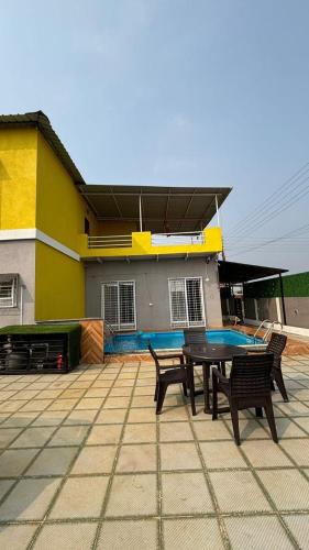 a ping pong table in front of a house at Nirvana Stays Shirol Shahpur in Khardi