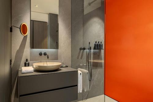 a bathroom with a sink and a glass shower at DAS AFFALTERBACH, Stuttgart, Autograph Collection in Affalterbach