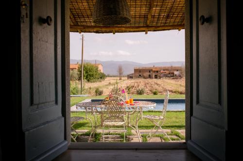 an open door to a patio with a table and chairs at Villa Il Nido in Cortona