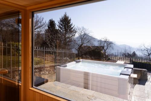 a hot tub sitting on a patio outside a window at Ca' Baetti l'Antica Corte in Roncola