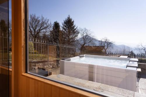 a hot tub sitting in a window with a view at Ca' Baetti l'Antica Corte in Roncola