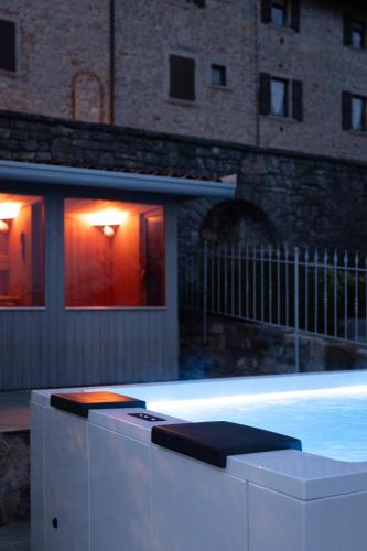 a swimming pool in front of a building at night at Ca' Baetti l'Antica Corte in Roncola
