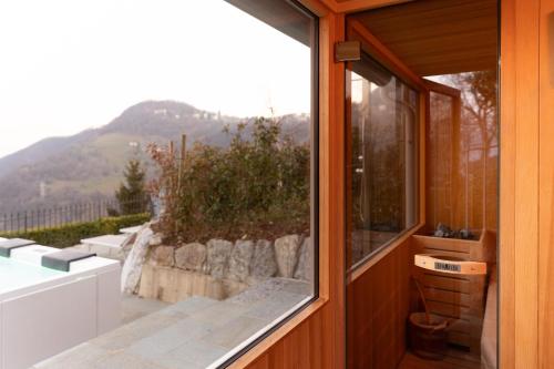 a house with a window with a view of a mountain at Ca' Baetti l'Antica Corte in Roncola