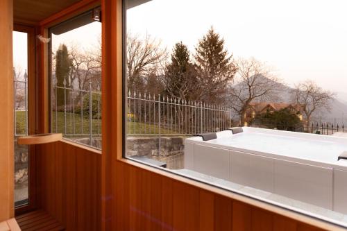 a room with a large window with a bath tub at Ca' Baetti l'Antica Corte in Roncola