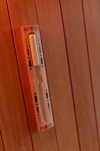 a wooden door with a thermometer on it at Ca' Baetti l'Antica Corte in Roncola