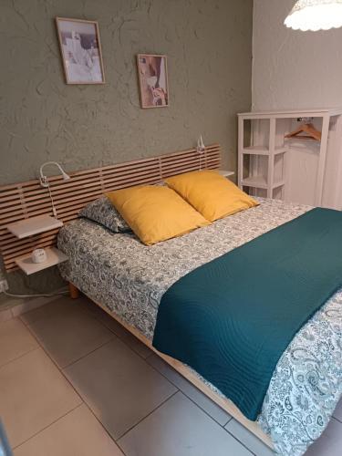 a bed with a wooden headboard in a bedroom at L'escapade d'Henry Dunant in Épernay