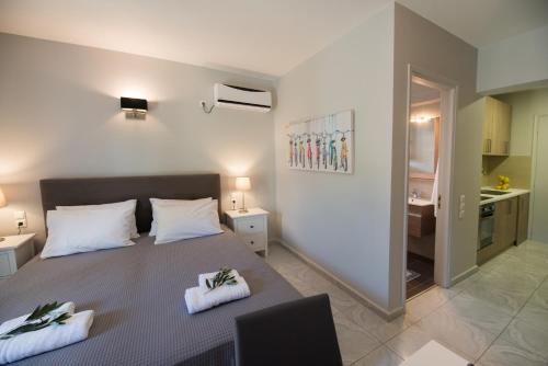 a bedroom with a bed with two towels on it at Regalo Apartments in Lygia