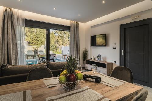 a living room with a table and a couch at Lumior Villas Lux essence by 'elite' in Zakynthos Town