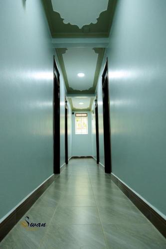 an empty hallway with a ceiling and a door at Swan Courts - Entebbe in Bugiri
