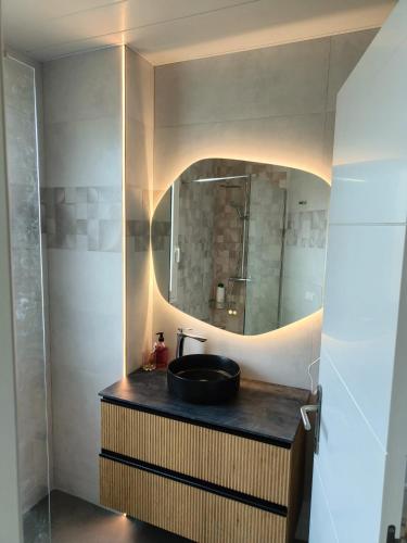 a bathroom with a sink and a mirror at ATICO DELUXE JACUZZI La Cala BENIDORM in Benidorm