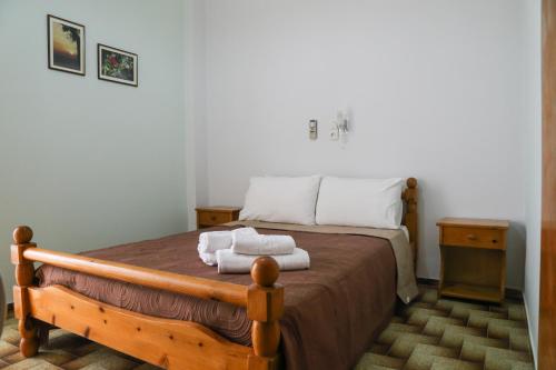 a bedroom with a bed with two towels on it at Panorama Rooms in Pyrgos Dirou