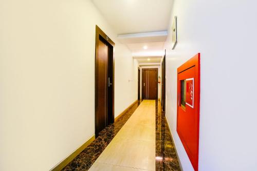 a hallway with two doors and a tile floor at FabHotel Prestige Nr Maapusa Bus Stop in Guirim