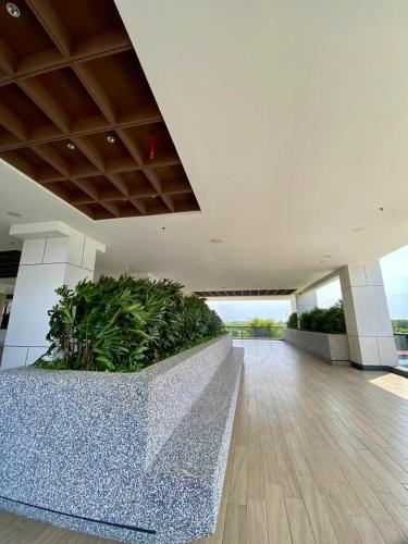 a lobby with a planter in the middle of a building at K avenue B3A 2bed studio room in Donggongon