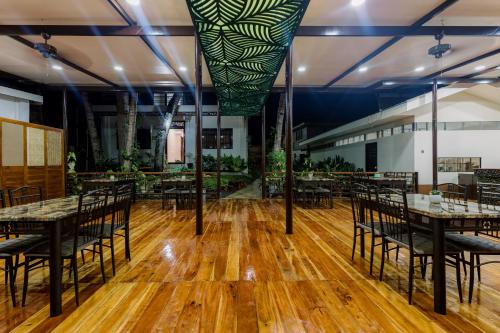 an empty banquet hall with tables and chairs at Loboc Riverside Inn & Restaurant in Loboc